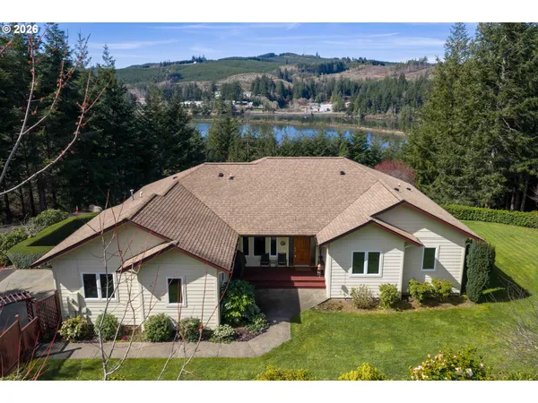 a aerial view of a house next to a yard
