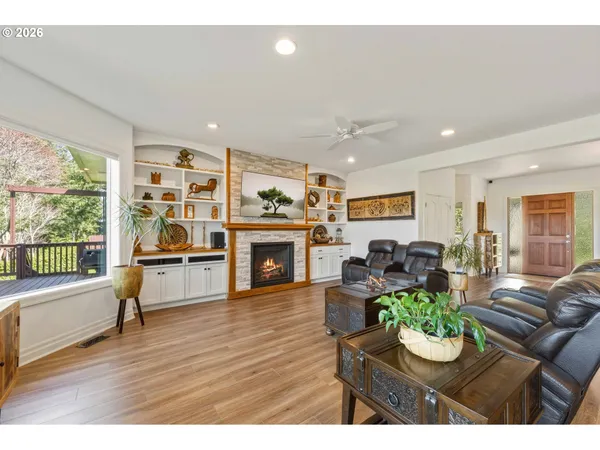 a living room with furniture fireplace and window