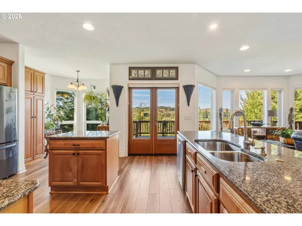 a kitchen with stainless steel appliances granite countertop a refrigerator stove and oven