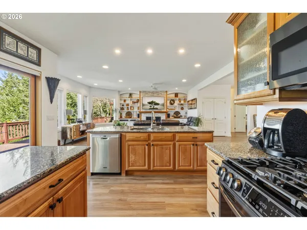 a kitchen with stainless steel appliances granite countertop a stove and cabinets