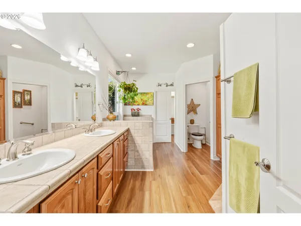 a spacious bathroom with a sink a mirror and a shower