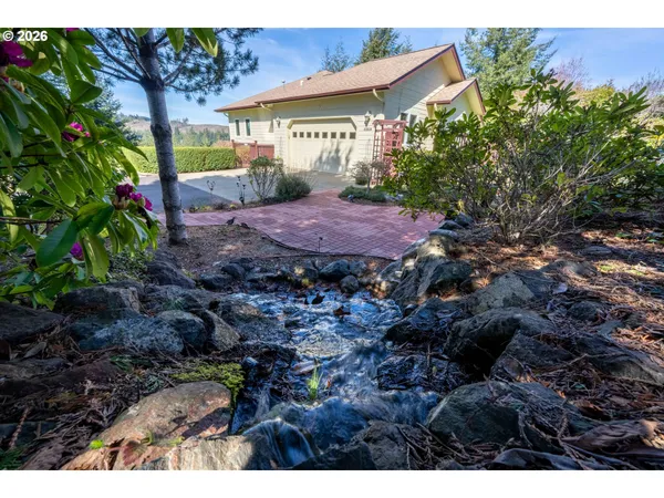 a view of a house with a small yard and plants