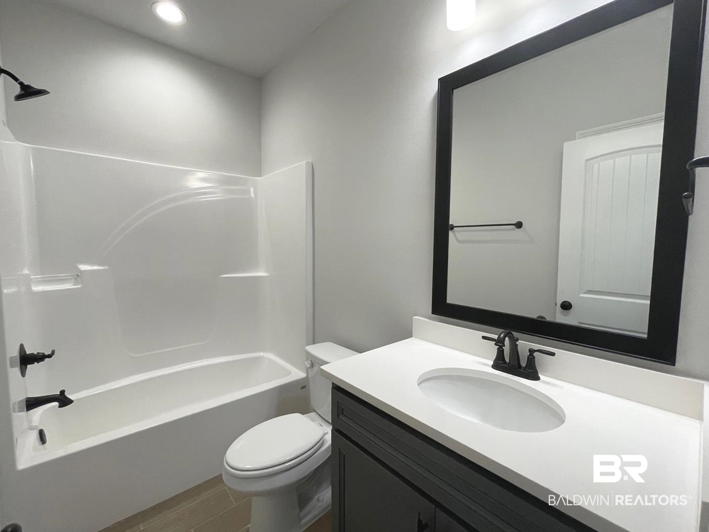 1424 Fenton Circle Foley, AL 36535 - Photo 14 of 20 Full bathroom with bathing tub / shower combination, tile patterned floors, toilet, and vanity