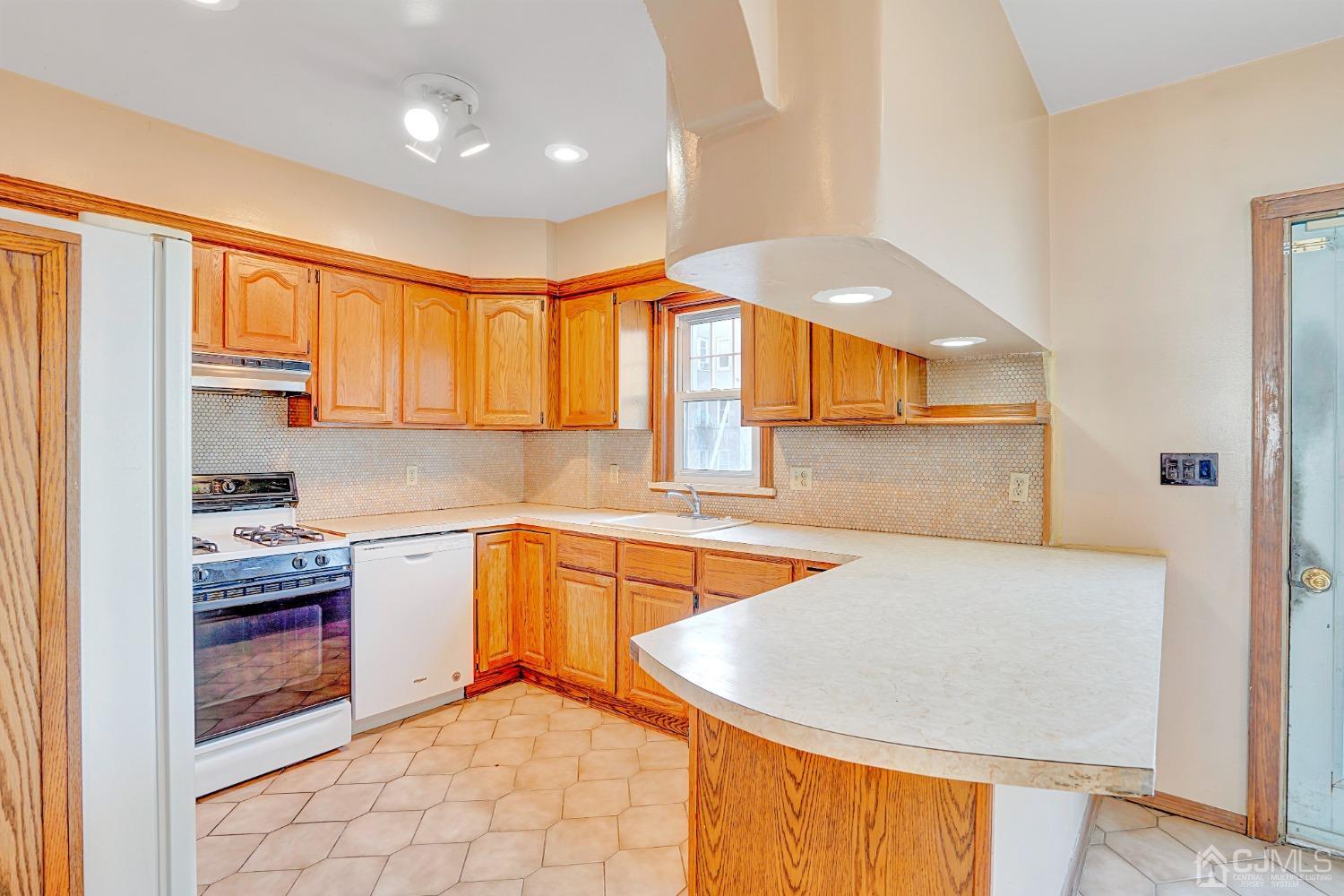 296 Argyle Place Kearny, NJ 07032 - Photo 13 of 38 a kitchen with stainless steel appliances granite countertop a sink and a white cabinets