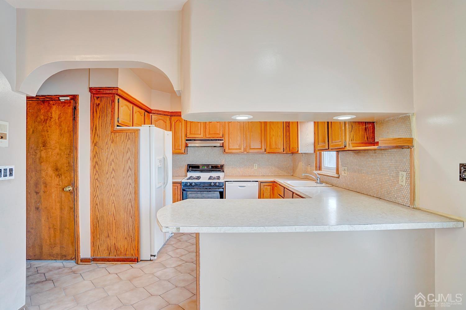296 Argyle Place Kearny, NJ 07032 - Photo 14 of 38 a kitchen with stainless steel appliances a refrigerator a sink a stove and cabinets