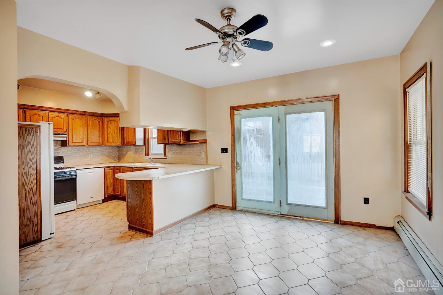 296 Argyle Place Kearny, NJ 07032 - Photo 15 of 38 a large kitchen with a large window cabinets and stainless steel appliances