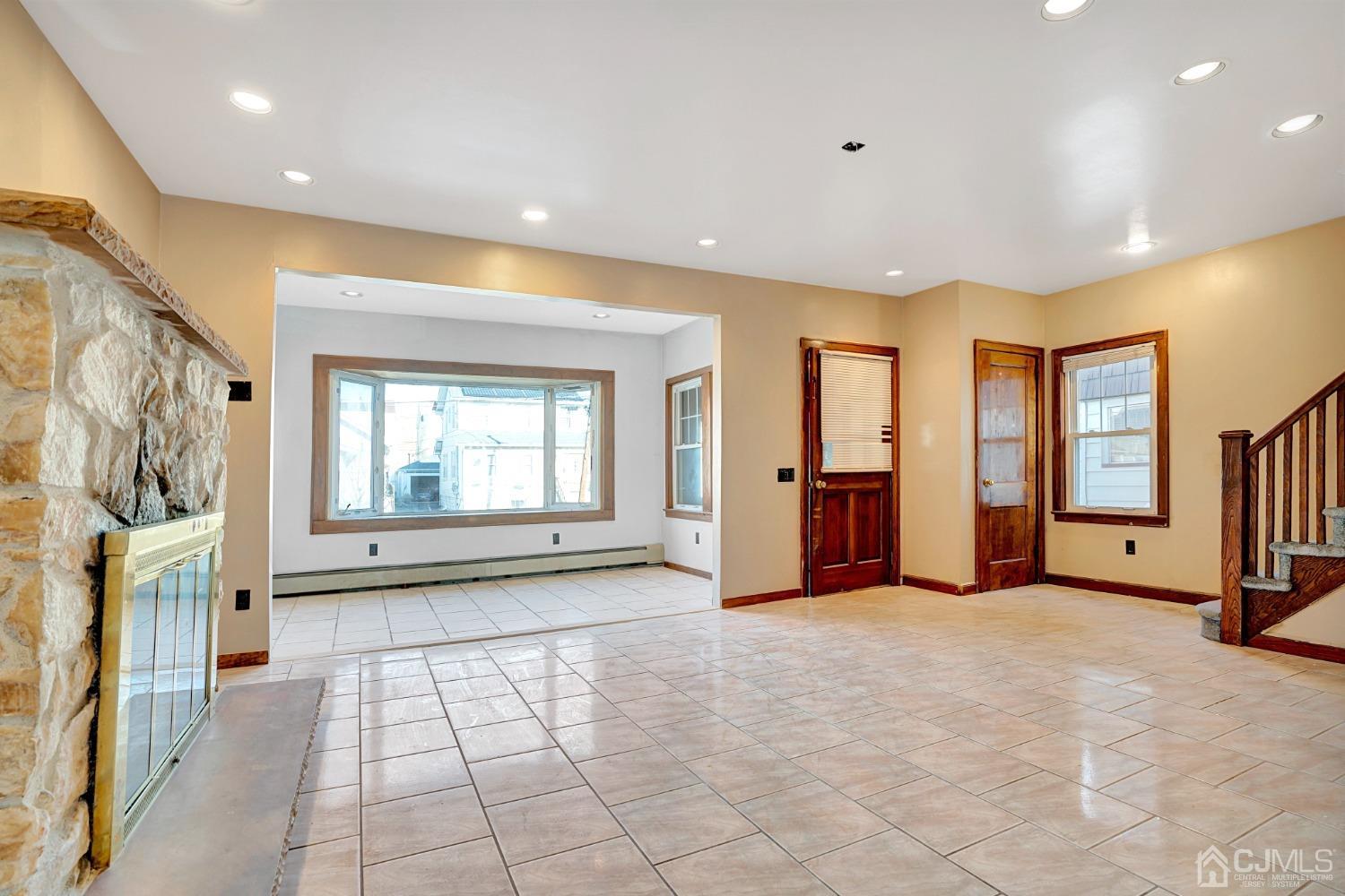 296 Argyle Place Kearny, NJ 07032 - Photo 8 of 38 a view of an empty room with a fireplace and a window