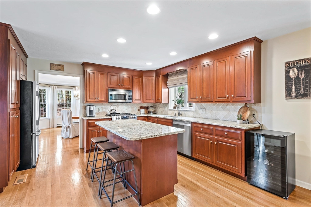 23 Northern Spy Road Franklin, MA 02038 - Photo 13 of 41 a kitchen with stainless steel appliances granite countertop wooden cabinets a center island and a refrigerator