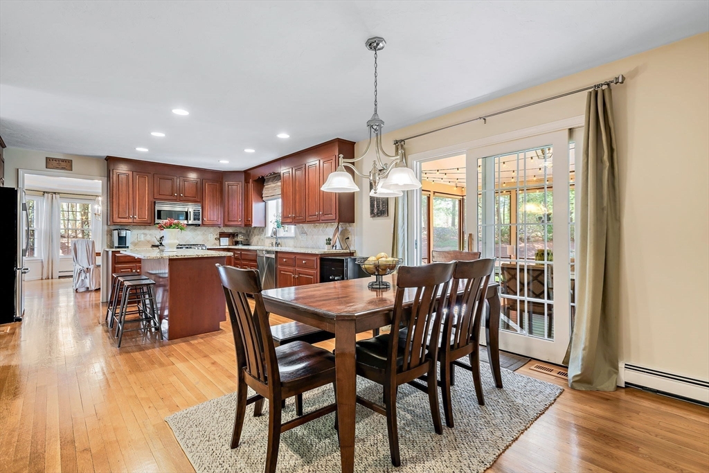 23 Northern Spy Road Franklin, MA 02038 - Photo 14 of 41 a dining room with stainless steel appliances granite countertop a dining table chairs and white cabinets