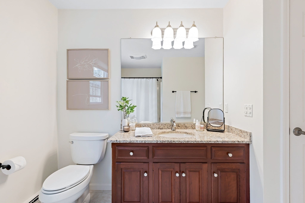 23 Northern Spy Road Franklin, MA 02038 - Photo 25 of 41 a bathroom with a granite countertop sink and a mirror with toilet