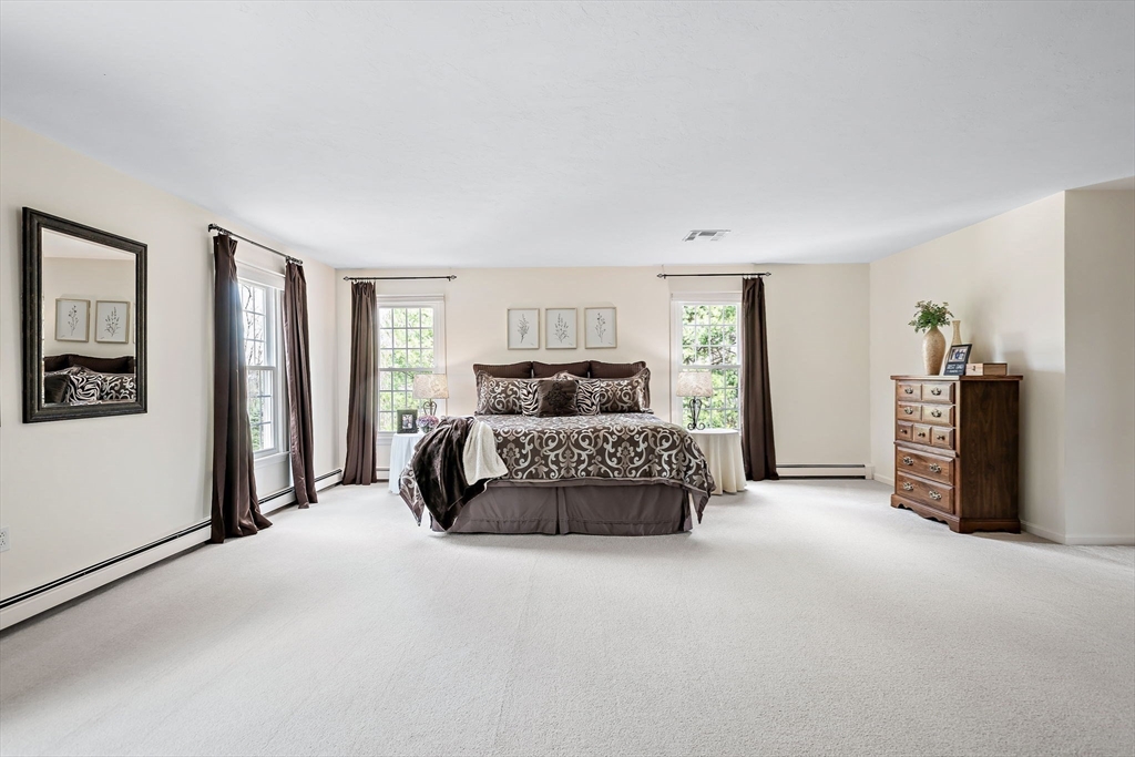 23 Northern Spy Road Franklin, MA 02038 - Photo 28 of 41 a bedroom with a bed and a large mirror