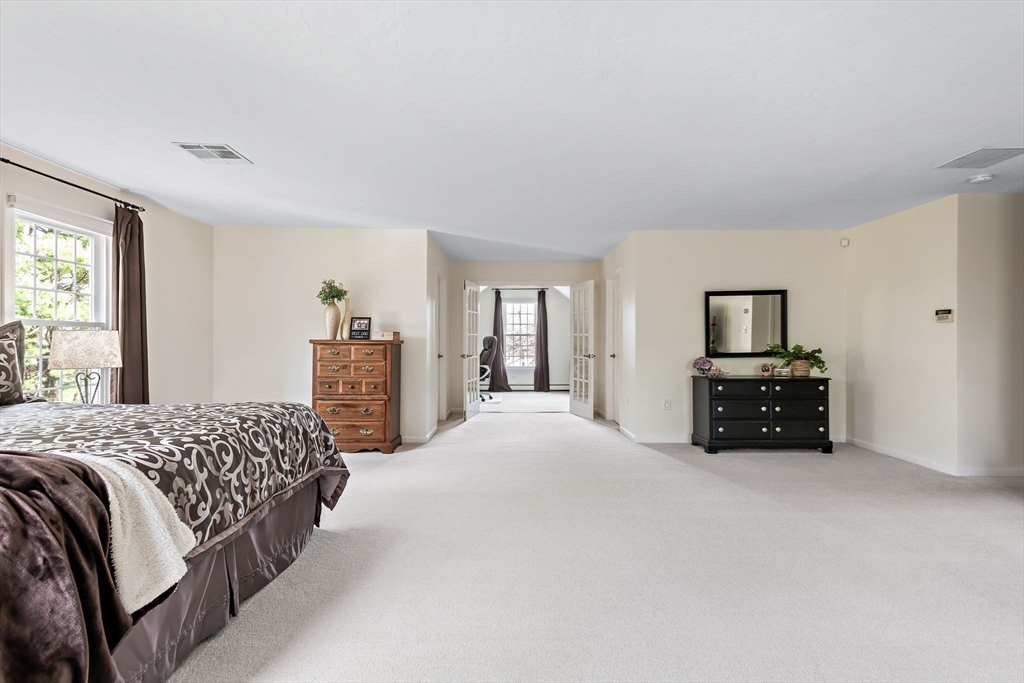 23 Northern Spy Road Franklin, MA 02038 - Photo 29 of 41 a spacious bedroom with a bed a dresser and a large window