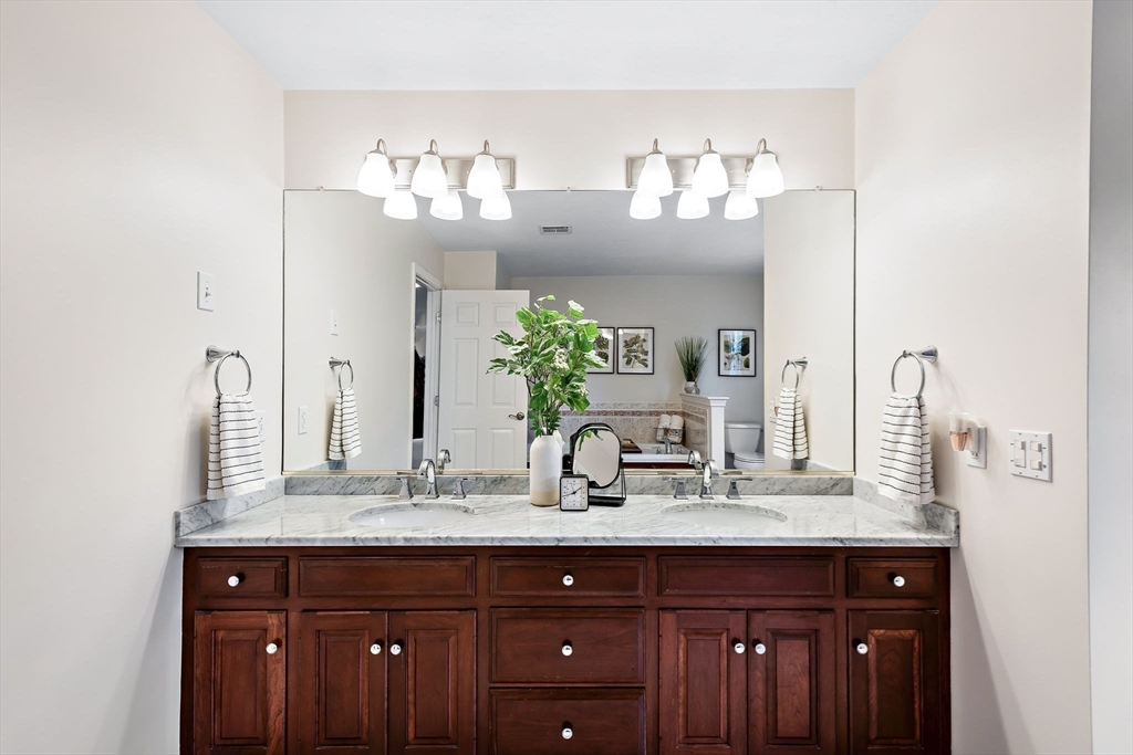 23 Northern Spy Road Franklin, MA 02038 - Photo 31 of 41 a bathroom with a granite countertop sink and a mirror