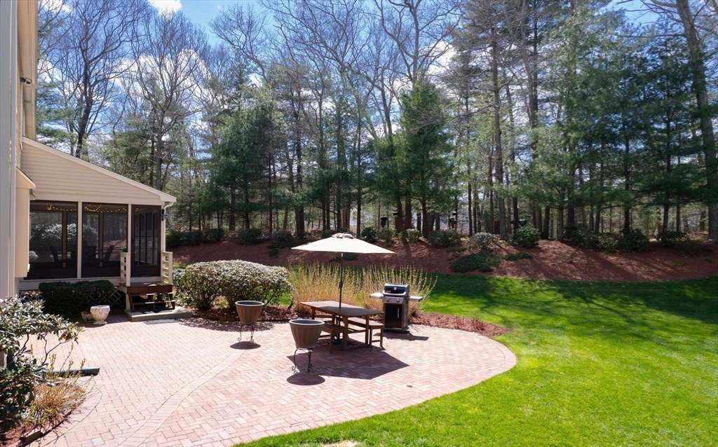23 Northern Spy Road Franklin, MA 02038 - Photo 37 of 41 a table and chairs under an umbrella in backyard