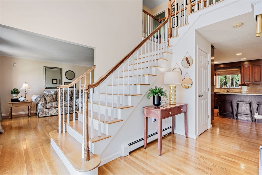 23 Northern Spy Road Franklin, MA 02038 - Photo 4 of 41 a dining room with wooden floor and a chandelier