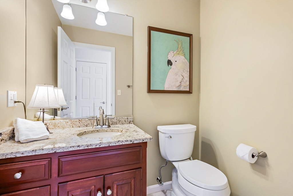 23 Northern Spy Road Franklin, MA 02038 - Photo 6 of 41 a bathroom with a granite countertop toilet sink and mirror