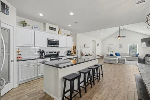 a kitchen with lots of counter top space and appliances
