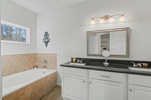 a bathroom with a bathtub and a sink