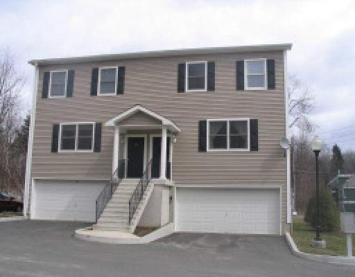 a view of a house with more windows and brick road