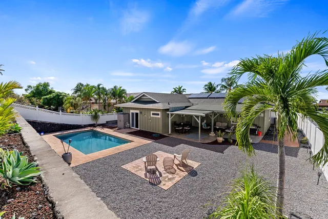 a view of a backyard with plants and a patio