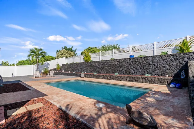 a view of a swimming pool and a yard