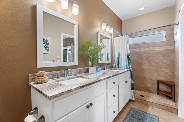 a bathroom with a granite countertop sink mirror and double