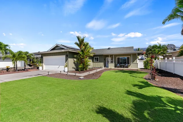 a view of house with a backyard and a patio