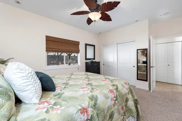 a bedroom with a large bed and a window