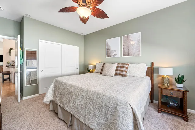 a bedroom with a bed and a chandelier