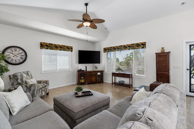 a living room with furniture a large window and a flat screen tv