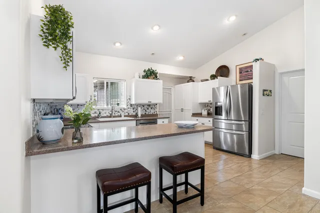 a kitchen with stainless steel appliances a sink and a refrigerator
