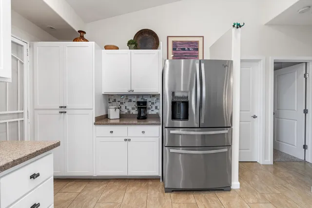 a kitchen with stainless steel appliances a refrigerator sink and cabinets