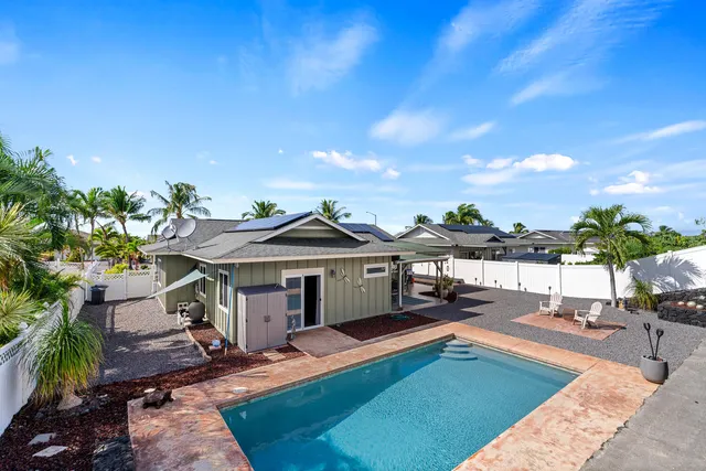 a view of a house with swimming pool and sitting area