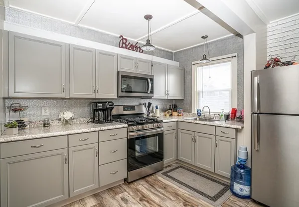 a kitchen with a sink appliances and cabinets