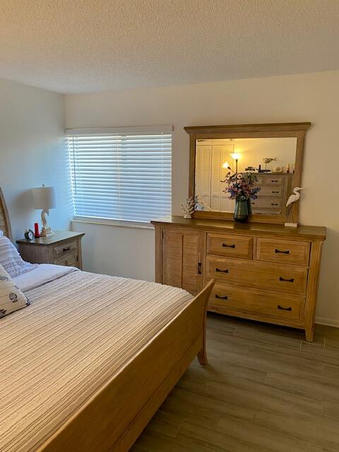 1605 Highway 1, Unit V2106 Jupiter, FL 33477 - Photo 11 of 18 a bed room with a bed and a dresser