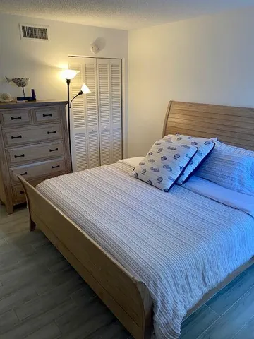 a bedroom with a bed and a dresser