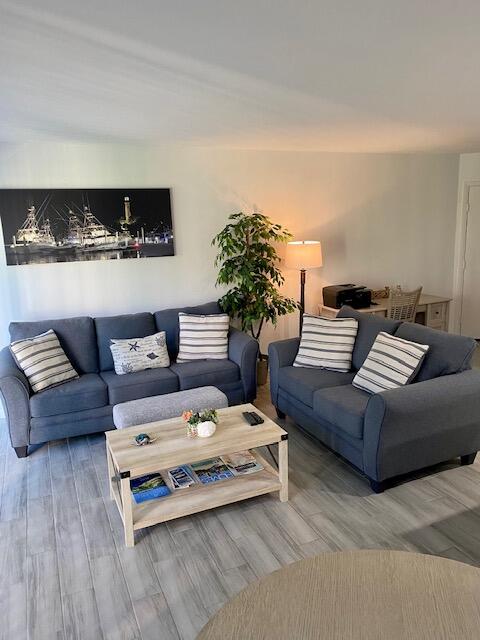 1605 Highway 1, Unit V2106 Jupiter, FL 33477 - Photo 2 of 18 a living room with furniture and wooden floor