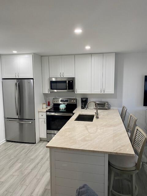 1605 Highway 1, Unit V2106 Jupiter, FL 33477 - Photo 5 of 18 a kitchen with a refrigerator a stove a microwave and white cabinets