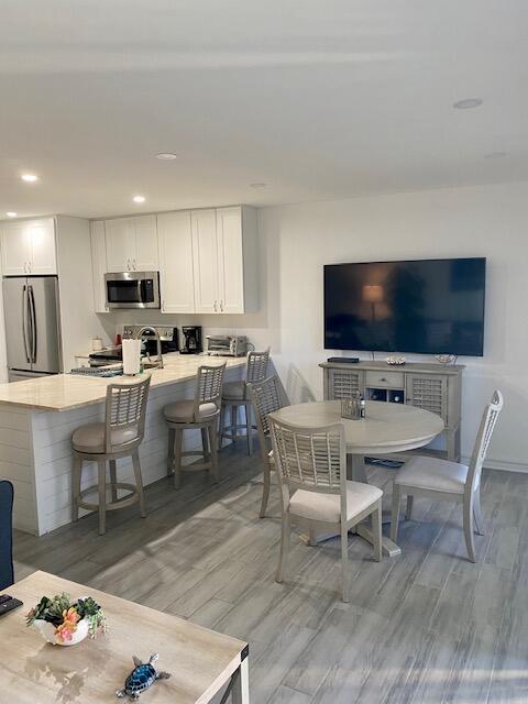 1605 Highway 1, Unit V2106 Jupiter, FL 33477 - Photo 8 of 18 a living room with furniture a flat screen tv and kitchen view