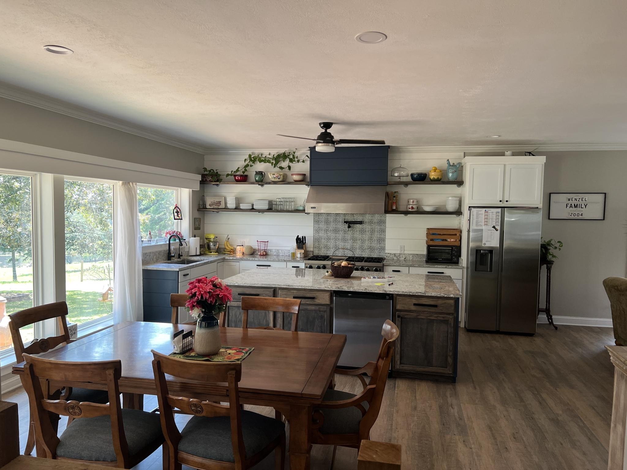 751 Bullman Road Finger, TN 38334 - Photo 6 of 22 a kitchen with stainless steel appliances a dining table chairs and wooden floor