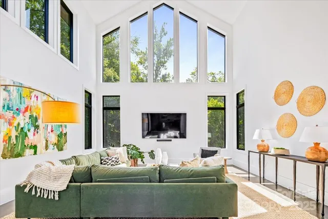 a living room with fireplace furniture and a large window