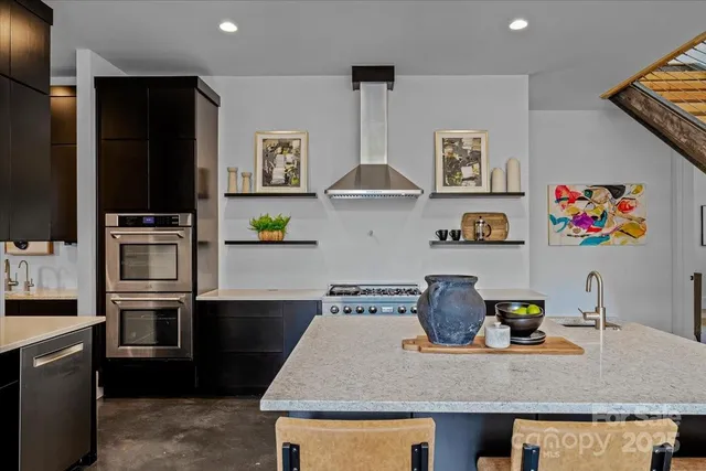 a kitchen with stainless steel appliances granite countertop a refrigerator and a sink