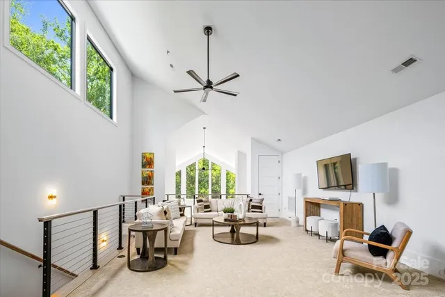 a living room with furniture a fireplace and a large window