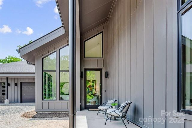 a backyard of a house with outdoor seating