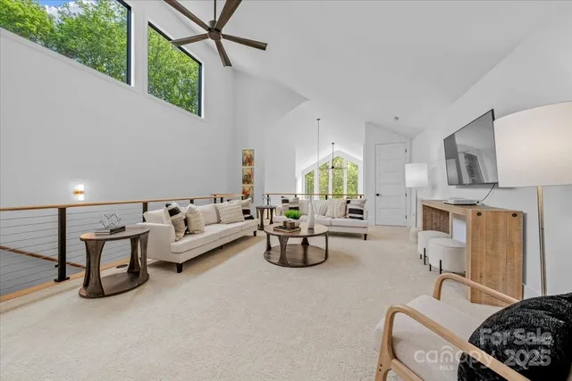 a living room with furniture and a chandelier