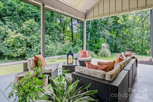 an aerial view of house with yard and outdoor seating