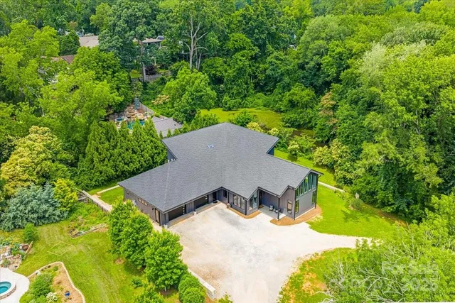 an aerial view of a house with a yard