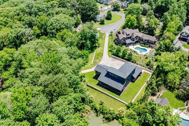 an aerial view of residential house with outdoor space and swimming pool