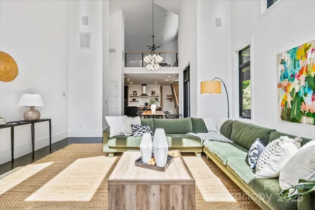 a living room with furniture and painting on the wall