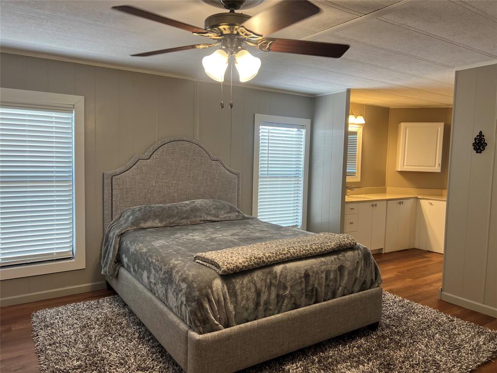 1059 Airport Road Graford, TX 76449 - Photo 15 of 35 a bedroom with a bed and a chandelier